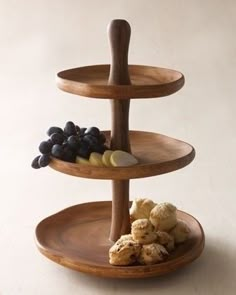 three tiered wooden plate with fruits and vegetables on it