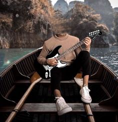 a man sitting in a boat playing an electric guitar