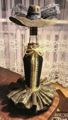 a bottle that has some kind of hat on top of it, sitting on a table