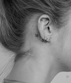 a woman's left ear with the word mom written in small letters on it