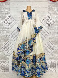 Beautiful Ethiopian and Eritrean Habeshan Dress. Stylish Menen, 100% Cotton We recommend hand washing and air drying to make it last longer. A low heating iron will also keep design and look. Beautiful Habeshan Dress |Ethiopian Traditional Dress|Eritrean Dress|Habesha Kemis|Zuria|Habesha Chiffon|Kemis Blue Ethiopian Dress, Gold Habesha Kemis, Habesha Traditional Dresses, Eritrean Traditional Dress, Eritrean Zuria Dresses, Ethiopia Traditional Clothing, Habesha Kemis For Graduation, Habesha Chiffon Dress, Modern Ethiopian Dress