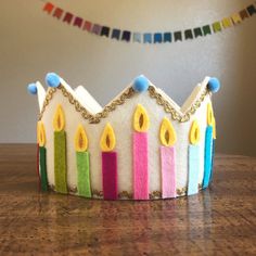 a crown made out of felt with candles on it