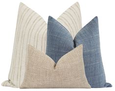 two blue and white pillows sitting next to each other