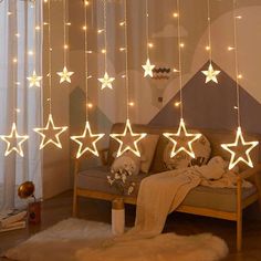 a living room filled with lots of lights and stars hanging from the ceiling above it