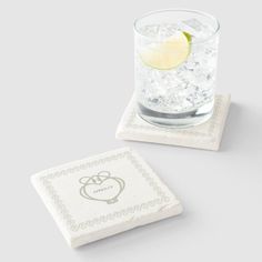 two coasters with the letter g and a lemon slice on top, one is made out of marble