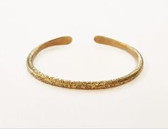 One Gold cuff  bracelet ,that stands out with it's special design.. one of a series of special  Bangles ( see them in my shop) that can be worn alone or a few together-as stackable cuffs.  A Unisex brass bangle bracelet, Boho cuff bracelet, This  beautiful  delicate piece of ethnic jewelry, Will give a special golden look to anything you were.  A special hand made present from Jerusalem   FEATURES: One cuff  bracelet Made of Brass Hammered and ornamented by hand, in an Ethnic style Shape: oval  Weight : 18.5 gr. Diameter : see in photos  Packaged carefully in a charming gift box. With a special small  polishing cloth for silver and brass jewelry. Delivery: Takes 7-28 Business days depending on your location. To see other BRACELETS with another design:     www.etsy.com/il-en/listing/1543138 Antique Gold Brass Cuff Bangle Bracelet, Bohemian Antique Gold Brass Bracelets, Festival Brass Bangle Cuff Bracelet, Festival Brass Cuff Bangle Bracelet, Bohemian Antique Gold Brass Cuff Bracelet, Adjustable Ceremonial Bangle Bracelets, Adjustable Ceremonial Bangle Cuff Bracelet, Adjustable Bangle Bracelets For Ceremonial Occasions, Bronze Brass Bangle Cuff Bracelet