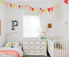 a baby's room with two cribs and a dresser