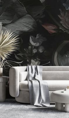 a living room with black and white wallpaper, couches, coffee table and potted plant