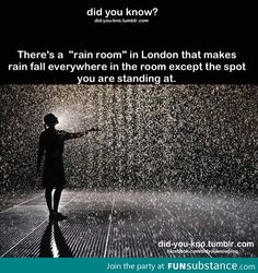 a person standing in front of a rain shower with the caption, there's a rain room in london that makes rain fall everywhere in the room except the