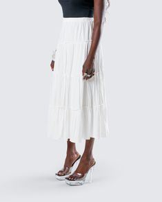 You’ll always be top tier in this white tiered maxi skirt 👑 Made from viscose challis fabric and featuring an elastic waistband and A-line design - this piece is the perfect closet staple to pair with everything 🤍 Flowy Tiered Maxi Skirt For Day Out, White Flowy Maxi Dress For Day Out, Beach Maxi Dress With Tiered Skirt And Elastic Waistband, White Maxi Length Skirt For Vacation, Chic Midi Dress With Ruffles, Chic Viscose Tiered Maxi Skirt, Vacation Tiered Ruffled Maxi Dress, Vacation Maxi Dress With Ruffled Tiered Skirt, White Tiered Midi Dress For Summer