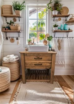 the bathroom is decorated in white and has plants on shelves above the sink, along with baskets