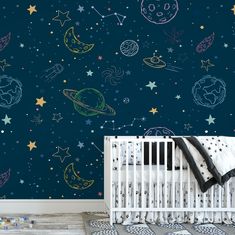 a baby's room with space wallpaper and crib in the foreground