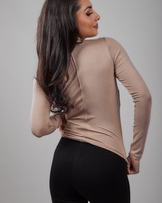 Made from our buttery soft domestically produced rayon spandex fabric these tops will easily become your go to T's. They can easily be worn at the office, with a pair of jeans, or as an elegant top for a long skirt. The back shaping seam helps to create that perfect hourglass silhouette and helps to keep it from sliding up your body. Made in USA providing jobs for American workers Pull over style Buttery soft rayon/spandex domestically produced fabric crew neck; long sleeves; back shaping seam H Elastane Fitted Tops For Workwear, Fitted Long Sleeve Elastane T-shirt, Stretch Elastane Long Sleeve T-shirt, Stretch Elastane Solid Color Blouse, Crew Neck Elastane Tops For Work, Stretch Elastane Tops For Workwear, Casual Taupe Stretch Top, Casual Stretch Taupe Top, Elastane Crew Neck Top For Work