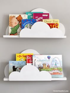 two white shelves with books on them in the shape of clouds, each holding children's books