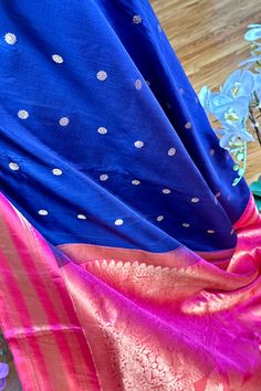 This beautiful Gadwal Silk Saree is a classic handwoven piece crafted using the finest silk. Show off your style in this elegant saree, featuring navy blue with buttis on the body while the kuttu borders and the grand pallu in two tone pink. The matching blouse piece is in two tone pink. Perfect for any special occasion, you'll love the quality and finish of this gadwal saree. Approximate Length 6.5 mtrs (inclusive of blouse length) Approximate Height - 48 - 52" Approximate weight - 1.6 lbs Sare Blue Tussar Silk Pre-draped Saree For Puja, Purple Katan Silk Pre-draped Saree, Blue Handloom Katan Silk Pre-draped Saree, Festival Blue Tussar Silk Pre-draped Saree, Luxury Blue Tussar Silk Pre-draped Saree, Silk Cotton Sarees, Elegant Saree, Blouse Length, Blouse Piece