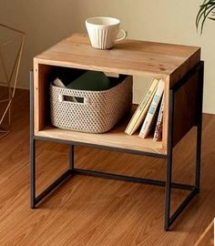 a small wooden table with a basket on it and a coffee cup sitting on top