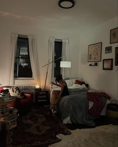 a woman sitting on top of a bed in a bedroom