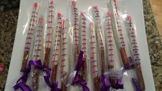 several sticks wrapped in plastic and tied with purple ribbon