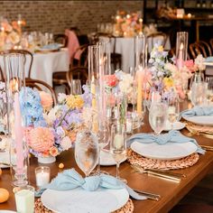 the table is set with flowers and candles for an elegant wedding reception or special event