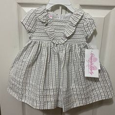 Nwt! Bonnie Jean Flutter Seersucker Dress & Matching Bloomer Size: 3-6 Months Color: Striped Gray, White & Silver Short Sleeved Seersucker Striped Empire Dress Features A Sailor Flutter And Tucked Hem Bundle & Save! Pet Free/Smoke Free Home! N9 Cotton Gingham Smocked Dress With Ruffles, Cotton Smocked Dress With Ruffles In Gingham, Cotton Smocked Dress With Ruffles For Playtime, White Smocked Dress With Ruffle Sleeves For Spring, Summer Smocked Short Sleeve Dress For Playtime, Cute White Smocked Dress With Short Sleeves, White Smocked Dress With Ruffle Sleeves, Spring Smocked Dress With Ruffles For Playtime, White Short Sleeve Smocked Dress For Playtime