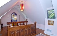 an attic bedroom with stained glass windows and wooden bed