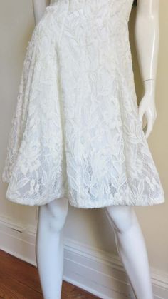 For Sale on 1stDibs - A gorgeous dress from Nina Ricci in white lace. From the front it is a simple V neck sleeveless A line dress in white lace. The back cut out from below Formal A-line Lace Dress With Lace Bodice, A-line Scalloped Lace Cocktail Dress, Cocktail A-line Lace Dress With Scalloped Lace, Cocktail A-line Scalloped Lace Dress, A-line Lace Dress With Patchwork For Garden Party, A-line Lace Patchwork Dress For Garden Party, White A-line Lace Dress With Lace Patchwork, A-line Lace Dress For Formal Occasions, A-line Lace Dress With Lace Sleeves For Wedding