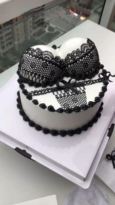 the cake is decorated with black lace and bows