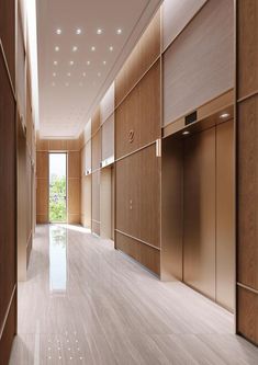 an empty hallway with wooden walls and doors