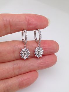 925 Sterling Silver Cz Guadalupe Dangle Huggie Hoop Earrings    - Metal: 925 Sterling Silver (Finish: Rhodium Plated) - Stone: Clear Cubic Zirconia, Round, Prong - Shape: Round Huggie Hoop(Cz Front, Plain Back) with Dangle Cz Guadalupe - Dimension: Total Length 26mm(1.02 in); Hoop: Outer Diameter 13mm(0.51 in), Inner Diameter 10.5mm(0.41 in), Face Width 1.5mm; Dangle Charm: 10mm(0.39 in) x 8mm(0.31 in), Thickness 1.5mm. (Center Guadalupe area: 5.8mm x 4mm) (Please note that the hoop's diameter i Silver Cubic Zirconia Dangle Huggie Earrings, Silver Dangle Huggie Earrings With Cubic Zirconia, Small Hoop Cubic Zirconia Jewelry With Halo Design, Dangle Hoop Earrings With Halo Design In Cubic Zirconia, Diamond White Sterling Silver Huggie Earrings With Halo Design, Silver Huggie Earrings With Halo Design, Cubic Zirconia Huggie Jewelry With Halo Design, Diamond White Huggie Jewelry With Halo Design, Silver Small Hoop Jewelry With Halo Detail