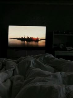 a flat screen tv sitting on top of a bed