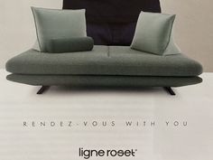 an advertisement for the ligne roset furniture line, featuring two green pillows and one black pillow