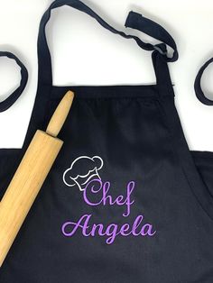 an apron with the word chef angela on it and a rolling pin next to it