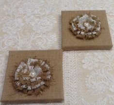 three pieces of burlap are sitting on a white tablecloth with lace and beads