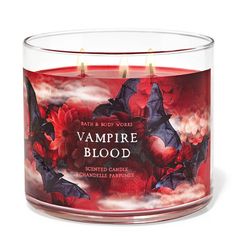 bath and body works vampire blood scented candle in glass container with red flowers on the inside