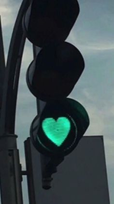 a traffic light with a green heart on it