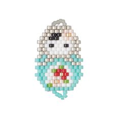 a small beaded bird hanging on a white wall