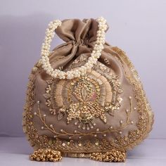 Beautiful Hand Embroidered Zardosi Work Golden Sequin Handbag Polti For Wedding Partys Giveaway Bridal Bag Shimmering Bag Dress Matching Bag Key Features: Embroidery art work This potli is good match with both Indian and western outfits and are superb for wedding and festive parties This would be best complement to your designer saree, lenhga or any other kind of dress This is the combination of traditional and modern embroidery work This is enough to keep your accessories and all needed essenti Bridal Potli Bags, Saree Bags, Shaadi Ideas, Wedding Party Bags, Sequin Handbag, Handbag Sewing Patterns, Zardosi Work, Wedding Handbag, Potli Bag