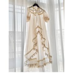 A long sheer cardigan with a sheer feel that will make you look like a princess of royalty. Lace embroidery decorates the edges, giving it a transparent and pure atmosphere. Wear it with a dress or jumper skirt. 
 

 

 
 
 Size 
 
 
 S size 
 
 Length: 112cm 
 Shoulder width: 35cm 
 
 M size 
 
 Length: 116cm 
 Shoulder width: 36cm 
 
 
 
 
 
 Material 
 
 Polyester 
 Rayon 
 
 
 Model worn 
 
 Wearing size 
 
 S size 
 
 Model dimensions 
 
 Height: 165cm Bohemian Chiffon Dress With Lace Trim, Long Sheer Lace Dress, Long Evening Dress With Lace Trim, Feminine Sheer Floor-length Dress, Sheer Feminine Floor-length Dress, Elegant Long Dress With Lace Patchwork, Elegant Vintage Dress With Lace Work For Spring, Victorian Dress With Lace Trim For Party, Elegant Sheer Daywear Dress