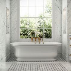 a white bath tub sitting next to a window