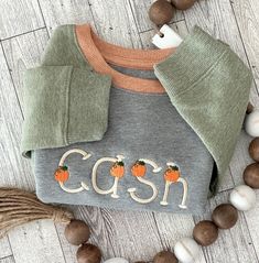 This toddler sweatshirt is perfect for your little one this fall! The perfect Personalized shirt for the season, featuring your Little One's Name on the front with Pumpkins. This sweatshirt will keep your little one warm and cozy all fall long!  Fit & style Made from a soft fleece fabric Banded cuffs and hem Fun prints and colors Recycled polyester Sizing: Toddler Material: 80% Cotton, 20% Recycled Polyester Hem Style: Ribbed Hem Fit: Casual Fit Fabric Name: Fleece Garment Style: Long Sleeve, Pullover Length: Below Hip Neckline: Crew Cuff Type: Ribbed Cuff Item Style: Basic Sweatshirts Visit our Shop for more Gift Selections SLCreationsLLC.etsy.com 💕🎃 Cute Sweater With Ribbed Cuffs For Fall, Cute Fall Loungewear Sweatshirt, Cute Fall Sweater With Ribbed Cuffs, Fall Sweatshirt With Embroidered Graphics, Fall Crew Neck Sweatshirt With Custom Embroidery, Fall Letter Patch Crew Neck Sweatshirt, Fall Crew Neck Sweatshirt With Name Print, Fall Cotton Sweatshirt With Embroidered Patch, Patch Crewneck