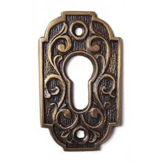 an antique style door handle on a white background with the key hole cut out to show it's ornate design