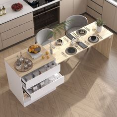 a kitchen table with plates and cups on it in the middle of a wooden floor