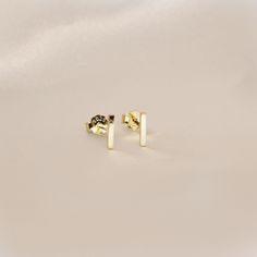 Simple Bar Stud Earrings- This listing is for a pair of the Bar Stud Earring. A perfect everyday piece to be worn alone or great layered with each other.- Base Material: High Quality Solid 925 Sterling Silver- Finish: 18K Gold or Rhodium- Measurement: 6mm - Nickel Free- All our jewelry is packaged in gift ready boxes. If you would like multiple items from your order packaged separately please let us know!© 2023 Generation of Daughters Lingot D'or, Gold Bar Earrings Studs, Bar Stud Earrings, Bar Studs, Stud Jewelry, Earrings Dainty, Gold Bar, Stud Earring, Jewelry Earrings Studs