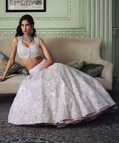 Radiate elegance with the lyana lehenga set in nude pink, featuring a lehenga adorned with precious flowers in silver and white embroidery. This sophisticated ensemble combines delicate hues with intricate detailing for a timelessly refined look. Glamorous Floral Embroidery Wedding Sets, Glamorous Wedding Sets With Floral Embroidery, Glamorous Pink Lehenga With Intricate Embroidery, Pink Pearl Embroidered Lehenga For Wedding, Pink Lehenga With Pearl Embroidery For Wedding, Glamorous Pink Lehenga For Wedding, Pink Wedding Lehenga With Pearl Embroidery, Glamorous Pink Wedding Lehenga, Floral Lehenga