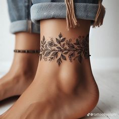 a woman's foot with a tattoo on it