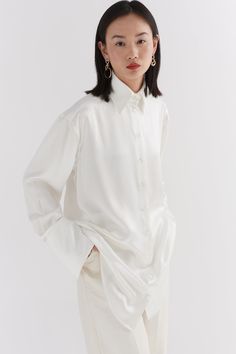 Our Ivory Silk oversized tailored shirt is made of 100% Silk. The shirt features a traditional collar, button stand with mother of pearl buttons and oversized cuffs with our signature button detail. Pink Wide Leg Trousers, Ivory Silk, Red Candy, French Seam, Candy Stripes, Tailored Shirts, Mother Of Pearl Buttons, Poplin Shirt, Pearl Buttons