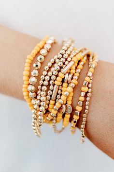 Multi layered 12 strands with gold tone beads, glass beads and tassel accent Available colors: White & Yellow Stretch Bracelets Acrylic, wood bead, zinc Nickel/lead compliant Approx. 2.75" diameter Fall Office Decor, Jelly Art Style, Fall Bracelets, Fall Bead, Stack Bracelets, Autumn Bracelet, Yellow Bracelet, Wood Bead Bracelet, Homemade Jewelry