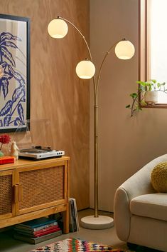 a living room scene with focus on the floor lamp and sofa in the foreground