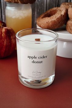 an apple cider donut is next to a candle