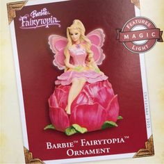 the barbie fairy doll is sitting on top of a flower